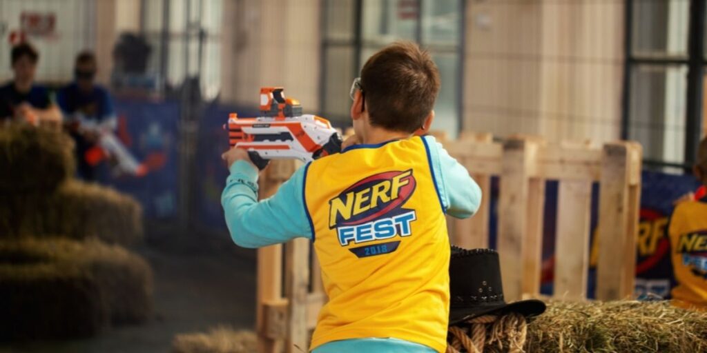 A boy shooting with nerf sniper gun